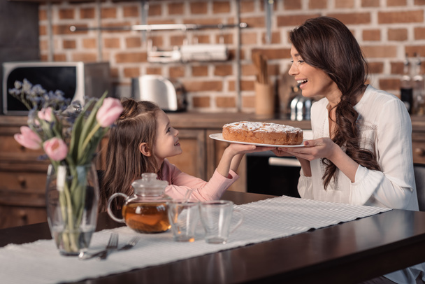 mother and daughter with cake - Photo, Image