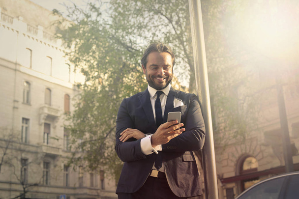 Businessman  with phone - Фото, изображение
