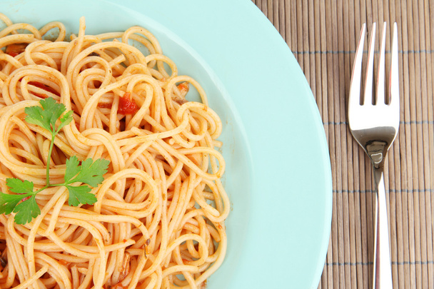 Italian spaghetti in plate on bamboo mat close-up - Photo, Image