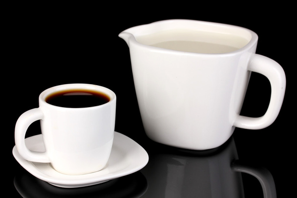 A cup of strong coffee and sweet cream isolated on black - Foto, immagini