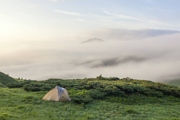 Hideg ködös nyári reggel és turisztikai túrázók sátorban panoráma - Fotó, kép