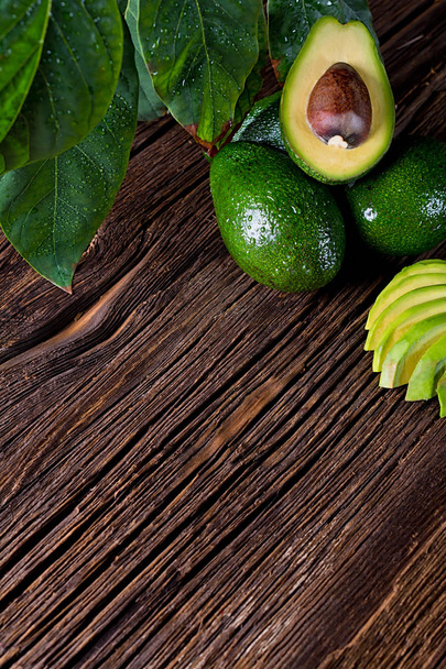 Avocado split in half on old wooden table with free space for your text. Top view. - Photo, Image
