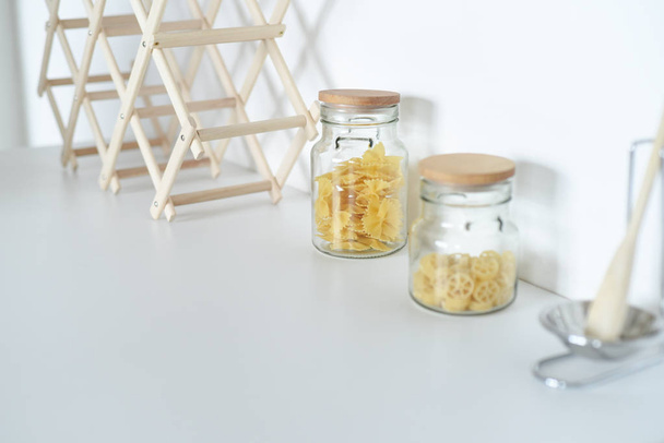 Jars with spices and condiments in the kitchen - Фото, изображение