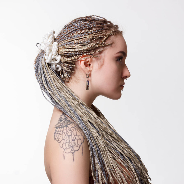 woman with stylish hairstyle from dreadlocks. - Fotó, kép