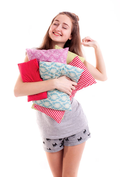 Pretty girl hold colour pillows isolated - Foto, afbeelding