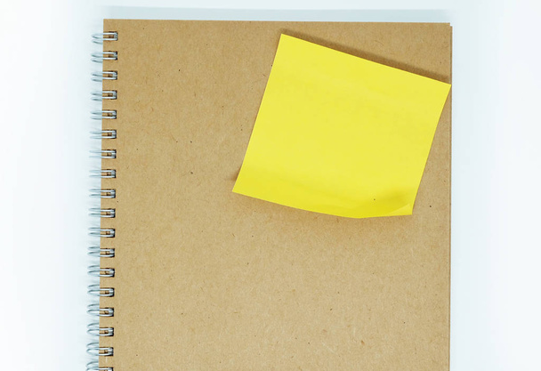 Yellow sticky note on notebook  - Foto, afbeelding
