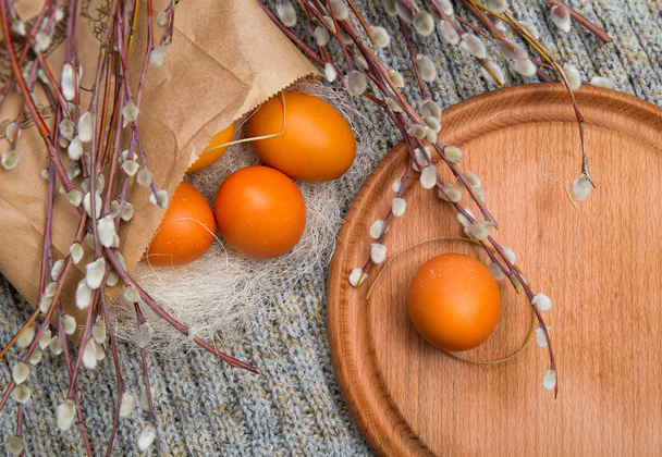 Easter colored eggs in a paper bag with branches of pussy willow - Photo, Image