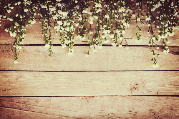 White flower on grunge wood board background with space. - Photo, Image