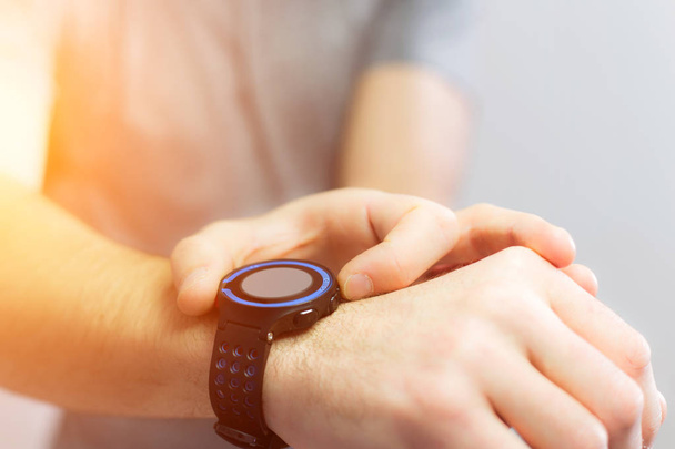 Hand holding black smartwatch with technology screen - Φωτογραφία, εικόνα