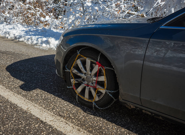 Chains on car weels in snowy mountains during winter - Photo, Image