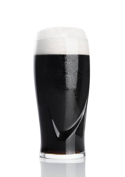 Glass of stout dark beer with foam and dew  - Photo, image