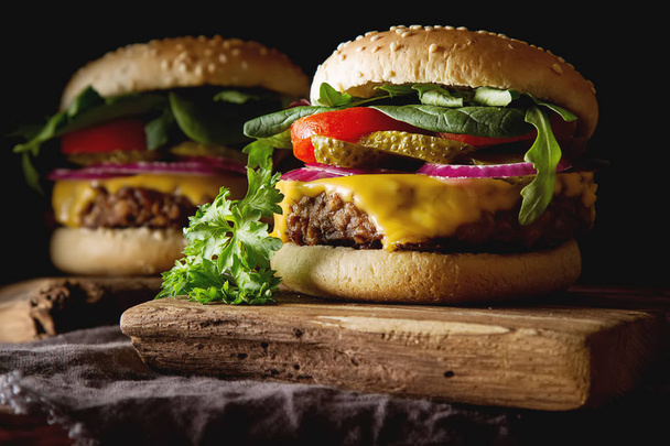 Fast food. Vegetarian burger with a chop, cucumber, tomato and l - Fotó, kép