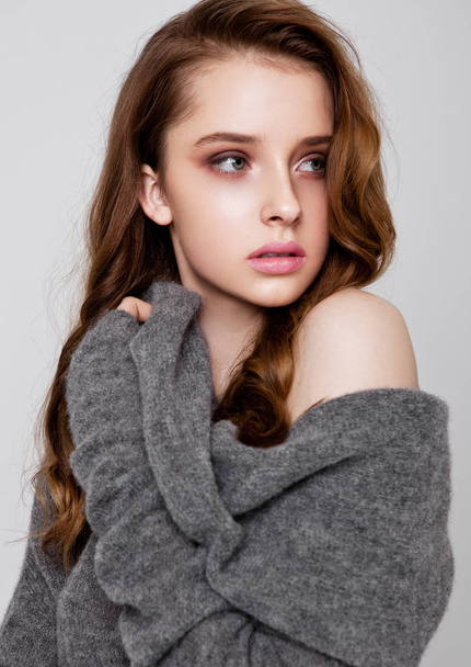 Young beautiful fashion model wearing knitwear  - 写真・画像