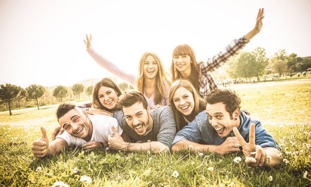 Ystävät ryhmä hauskaa yhdessä omakuva ruoho niitty - Ystävyys nuoriso konsepti nuorten onnellisia ihmisiä piknikillä retkeily ulkona - Lämmin vintage suodatin taustavalo kontrasti auringonpaiste
 - Valokuva, kuva