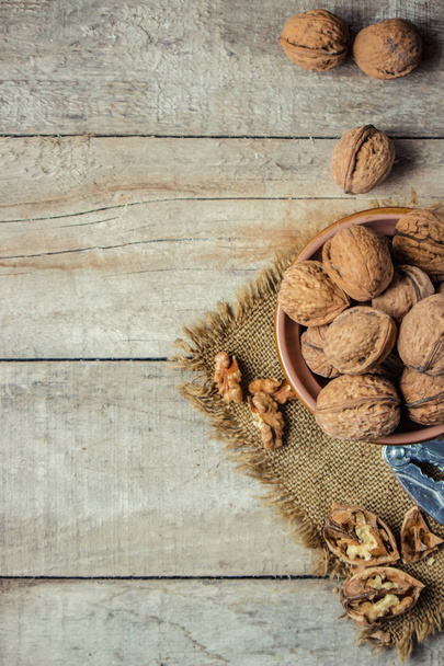Walnuts on wooden background. Selective focus.  - 写真・画像