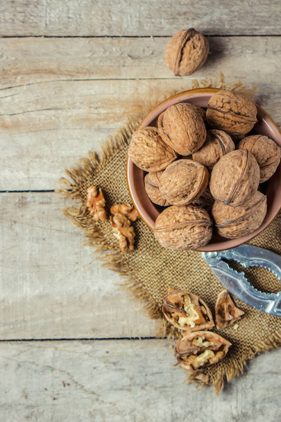 Walnuts on wooden background. Selective focus.  - Foto, afbeelding