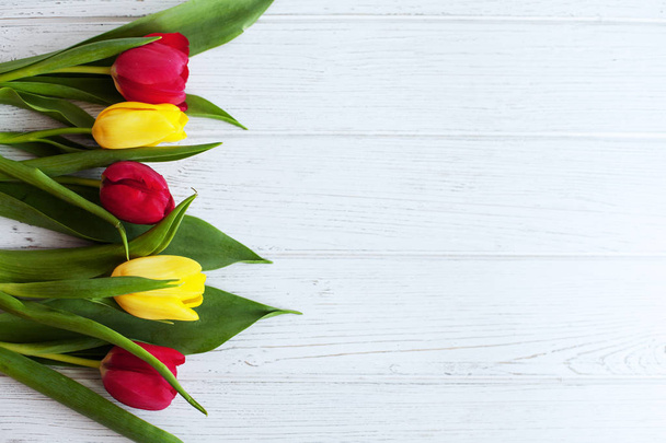Wooden white background with tulips. Conception holiday, March 8 - Φωτογραφία, εικόνα
