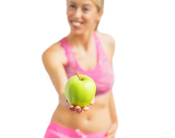 Healthy woman standing with apple in her hand - Photo, Image