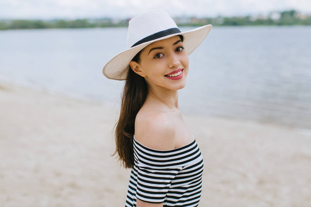 woman with hat  on the beach - 写真・画像