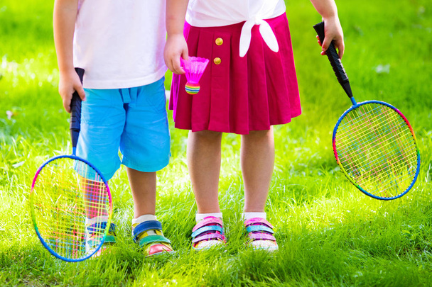 Kids play badminton or tennis in outdoor court - Fotoğraf, Görsel