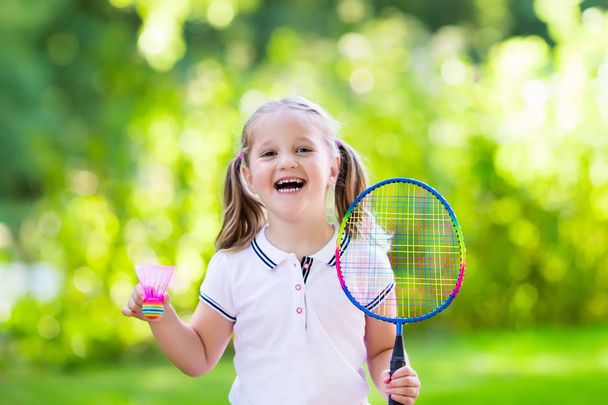 Child playing badminton or tennis outdoor in summer - Fotoğraf, Görsel