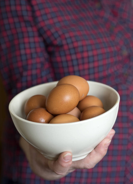 woman holding a bowl of eggs - Fotografie, Obrázek