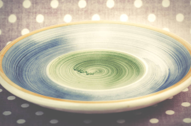 Empty blue and green plate on pink dotted background. - Foto, imagen
