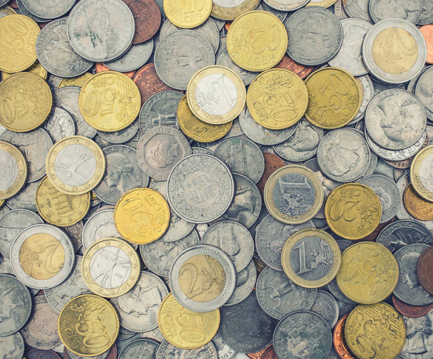 Coins of several currencies - background pattern. - 写真・画像