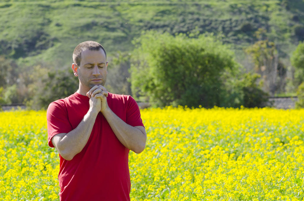 Praying alone in nature with hand clasped. - Photo, Image