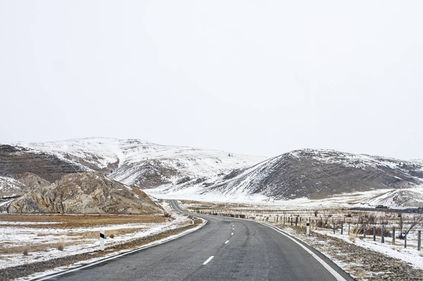 Winding road in the beautiful mountains in the winter on Baikal. - 写真・画像