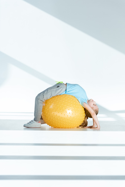 Girl exercising on fitness ball - Fotó, kép