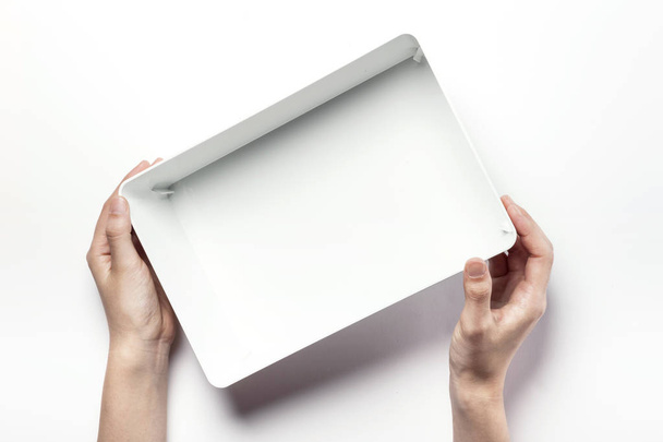 holding a white box - Foto, imagen