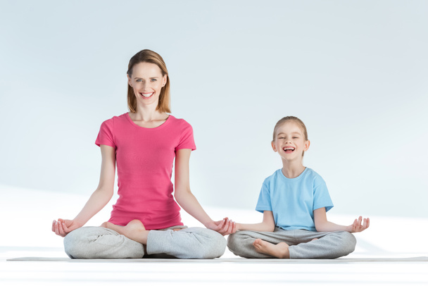 Mother and daughter in lotus position - Photo, Image