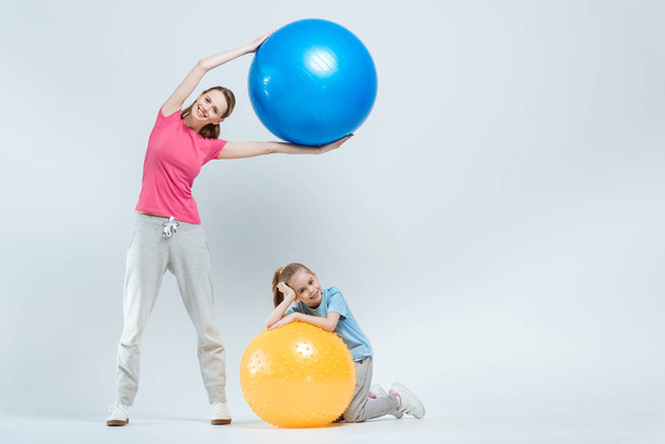 mother and daughter with fitness balls - Φωτογραφία, εικόνα