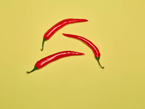 bitter chili pepper and paprika on a yellow background - Fotoğraf, Görsel
