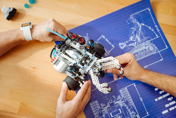 Professional engineers holding robot - Φωτογραφία, εικόνα