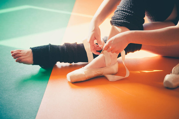 dancer woman putting on ballet shoes - Фото, зображення