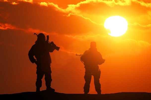 Two silhouette of a soldier on a beautiful background - Photo, Image