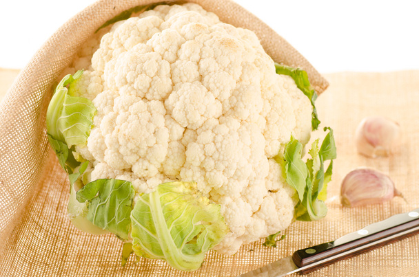 Cauliflower with burlap sack on white - Photo, Image