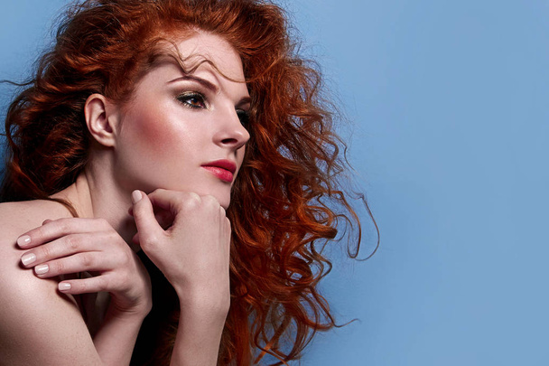 Beautiful red-haired cute girl with curly hair. - Фото, изображение