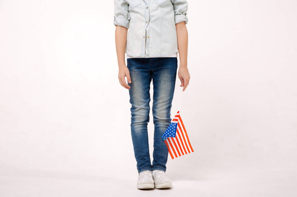 Little child holding American symbol in the studio - Foto, afbeelding