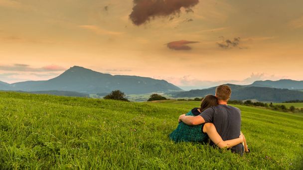 Couple watching the sunset on a meadow in Slovakia - Foto, immagini