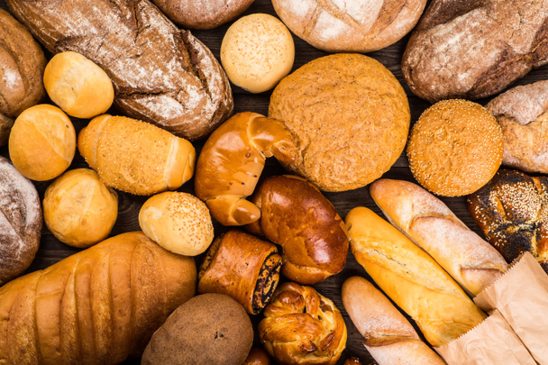 Many mixed breads and rolls shot from above. - Photo, Image