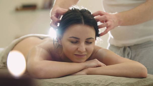 Salone massaggi - giovane donna ottiene rilassante terapia curativa per la testa e i capelli
 - Foto, immagini