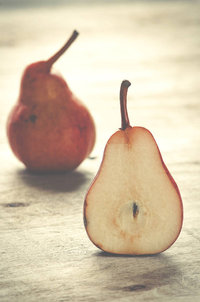 Red pears on wooden background. Autumn fruits. - Photo, Image