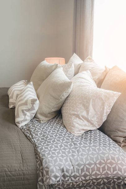 set of pillows on bed in cozy bedroom - Photo, Image