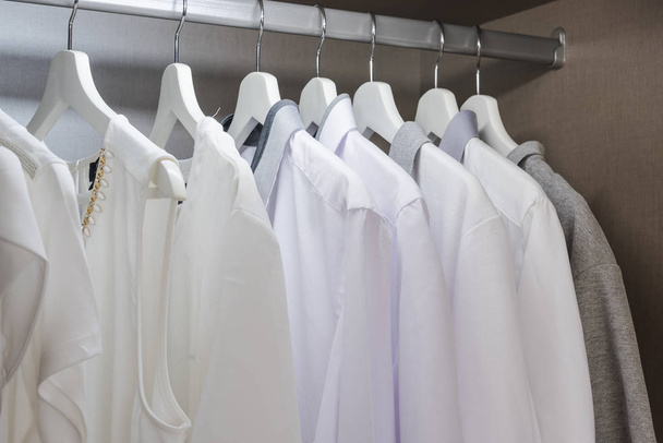 white shirts hanging on rail in wooden wardrobe - Photo, Image