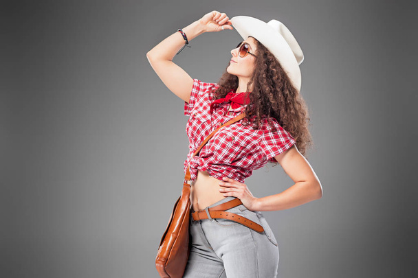 The cowgirl fashion woman over a gray background - Фото, зображення