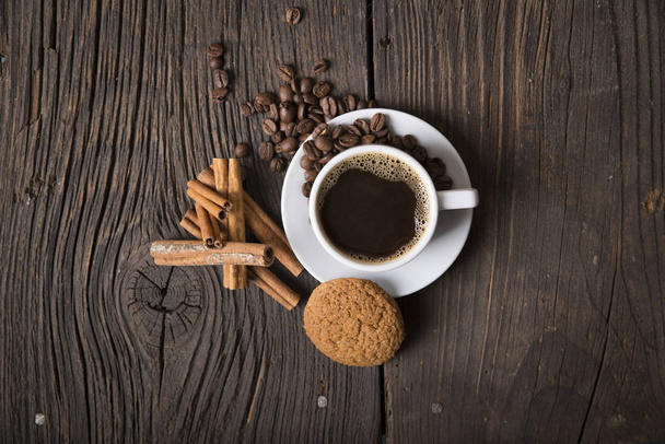 Cup of coffee with brown sugar on a wooden table. - Fotoğraf, Görsel