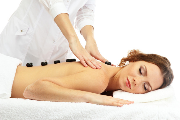beautiful young woman in spa salon getting massage with spa stones - Фото, зображення